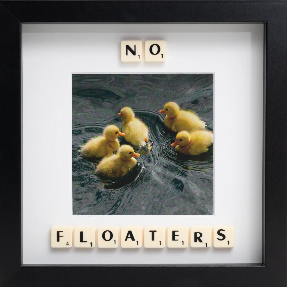 Capture a special moment with the "NO FLOATERS - Scrabble Print," featuring five yellow ducklings on water. Scrabble tiles above and below spell out NO FLOATERS—perfect for evoking fun memories!. Gate21.ee