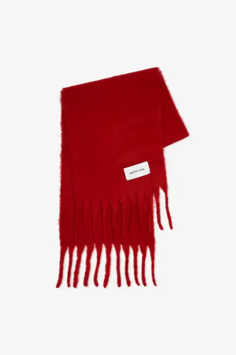 The Stockholm Scarf - Crimson Red features a bright red colour, long thin fringes at both ends, and a white rectangular “ARCTIC FOX Stockholm” label, shown against a plain white background. Gate21.ee