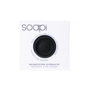 Soapi - Black, a circular magnetic soap holder, is displayed on white packaging. Made from about 90% recycled plastic, it’s waterproof, strong, and long-lasting. Gate21.ee