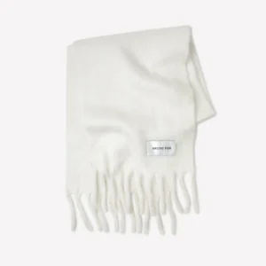 The Stockholm Scarf - Polar White is a folded white scarf with fringed ends and a small rectangular ARCTIC FOX STOCKHOLM label, displayed on a plain white background. Gate21.ee