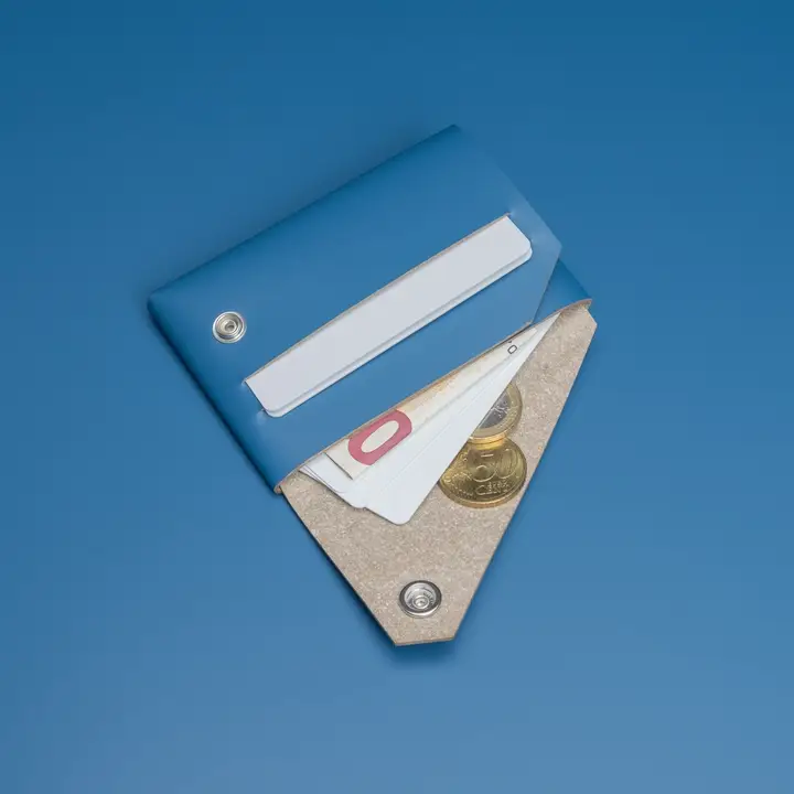 The LEMUR – Blue Wallet, envelope-style, is open to display cards and coins inside. It rests on a plain blue background. Gate21.ee