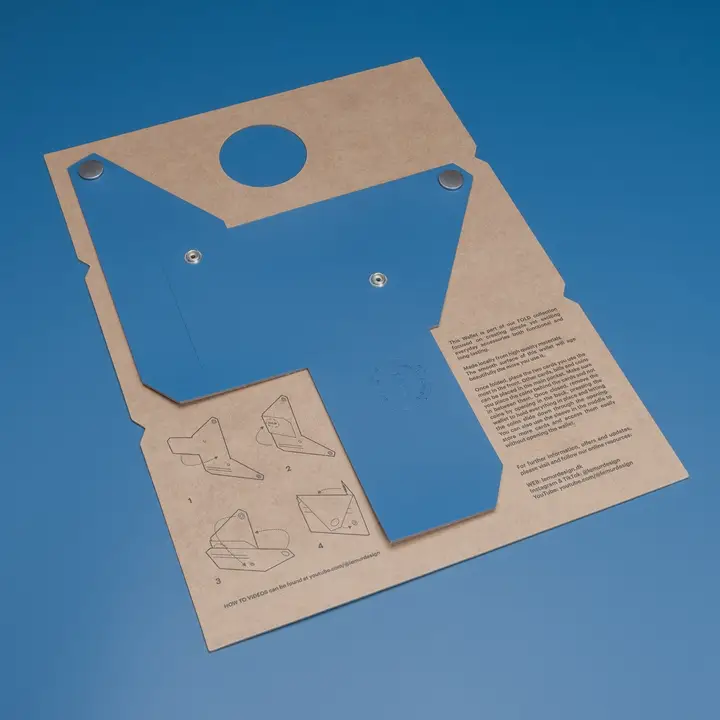 A flat blue and tan cardboard sheet with perforations, fold lines, metal poppers, and printed instructions is shown on a blue background. This template kit folds into the LEMUR - Blue Wallet. Gate21.ee