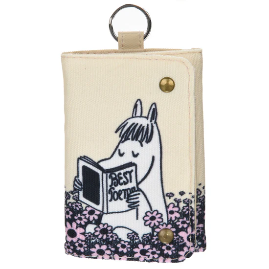 The Moomin Wallet - Snorkmaiden Reading is a beige fabric wallet with brass poppers, showing Snorkmaiden among pink flowers reading "Best Sort of." It doubles as a cute keyring, with a metal keyring on top for easy carrying. Gate21.ee