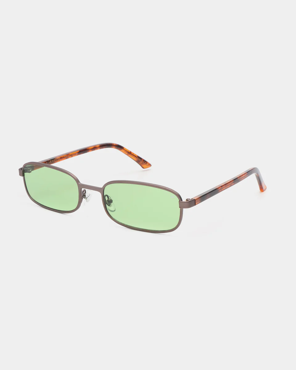 The NOAH - Gun Metal Havana sunglasses by A. Kjærbede feature rectangular light green tinted lenses, slim dark metal frames, and brown marbled arms, displayed against a plain white background. Gate21.ee