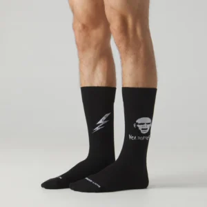 A person wears black Harry Potter - Voldemort socks from Jimmy Lion; the left sock has a lightning bolt, and the right shows Voldemort’s face with “You Serious?” below. The background is plain light grey. Gate21.ee