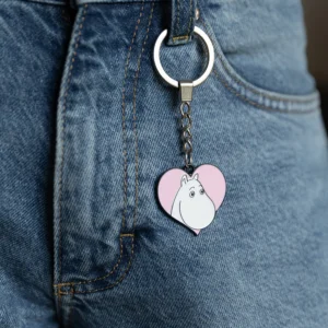 The Moomin Keyring - Troll Heart, shaped like a heart and featuring the iconic character, is attached to the belt loop of blue denim jeans. Gate21.ee