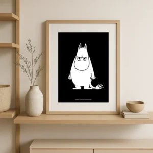The Moomin Poster - Troll Temper, featuring a white cartoon creature with a serious expression on a black background, is displayed on a beige shelf with a vase, bowl, decorative twig, and whimsical Moomin keyrings. Gate21.ee