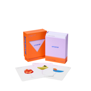 A partly open box labelled "The Cocktail Cabinet: Aperitif" reveals a stack of cards, with three displayed in front showing illustrated cocktail recipes on a white background. Gate21.ee