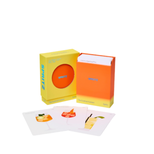 The Cocktail Cabinet: Spritz is a boxed set featuring a deck of cocktail recipe cards with vibrant drink illustrations. Three colourful cocktail cards are displayed in front of the packaging. Gate21.ee