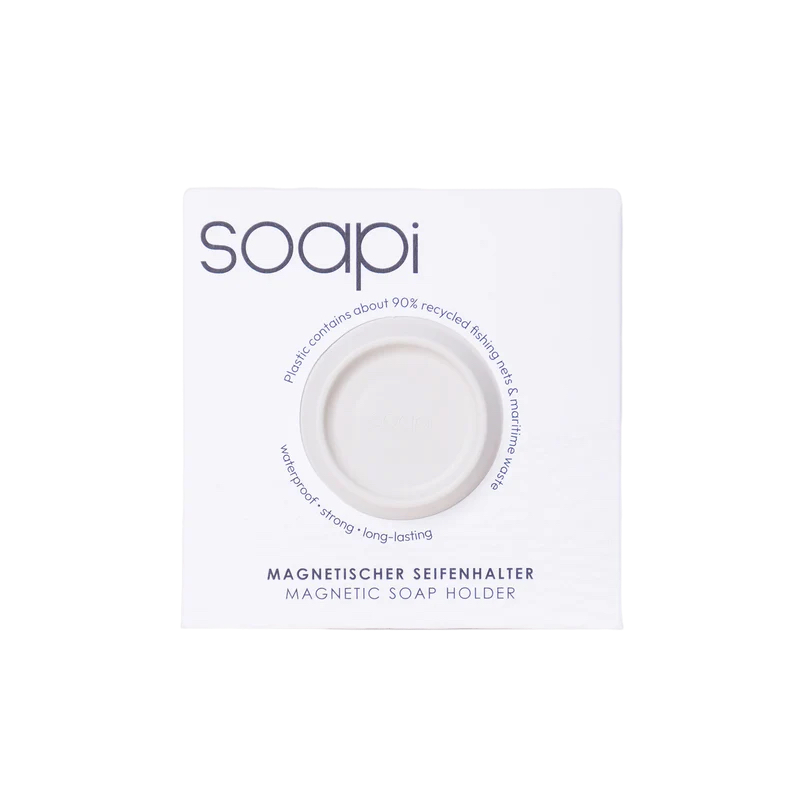 The Soapi - Off White box includes a round magnetic soap holder made from about 90% recycled fishing nets. Its waterproof, durable design combines sustainability with everyday convenience. Gate21.ee