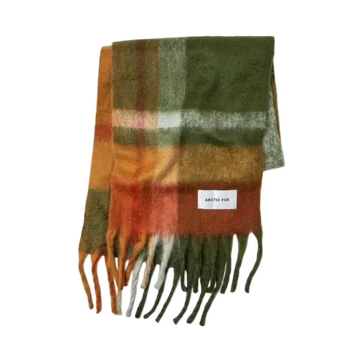 The Stockholm Scarf - Mossy Spring is a rectangular, multicoloured checked scarf in green, orange, brown, and white with fringed ends and an Arctic Fox Stockholm label. Shown on a plain white background. Gate21.ee