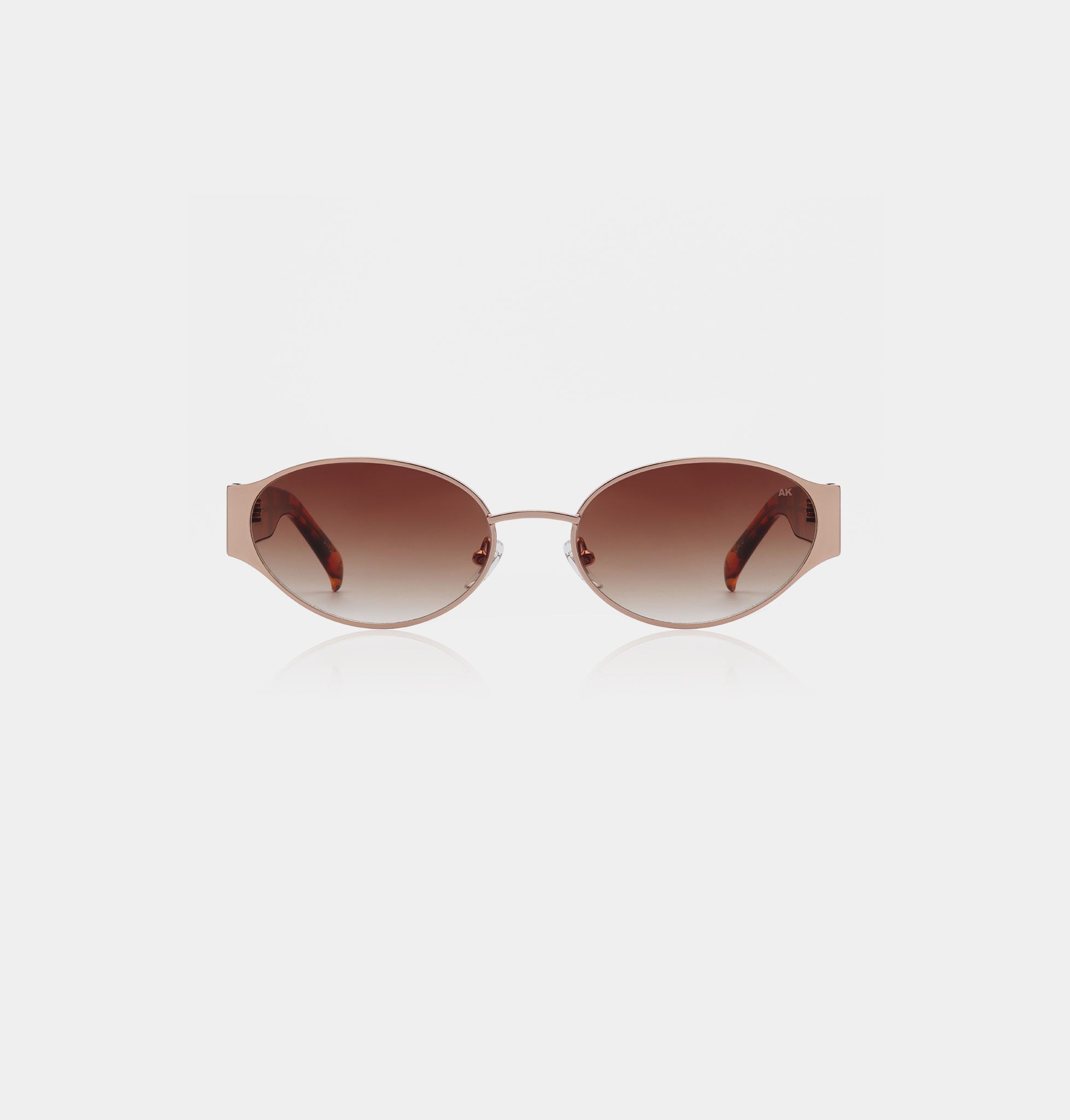 The Bella - Rosegold Havana sunglasses by A. Kjærbede feature round lenses, thin metal frames, and brown graduated lenses, displayed on a plain white background. Gate21.ee