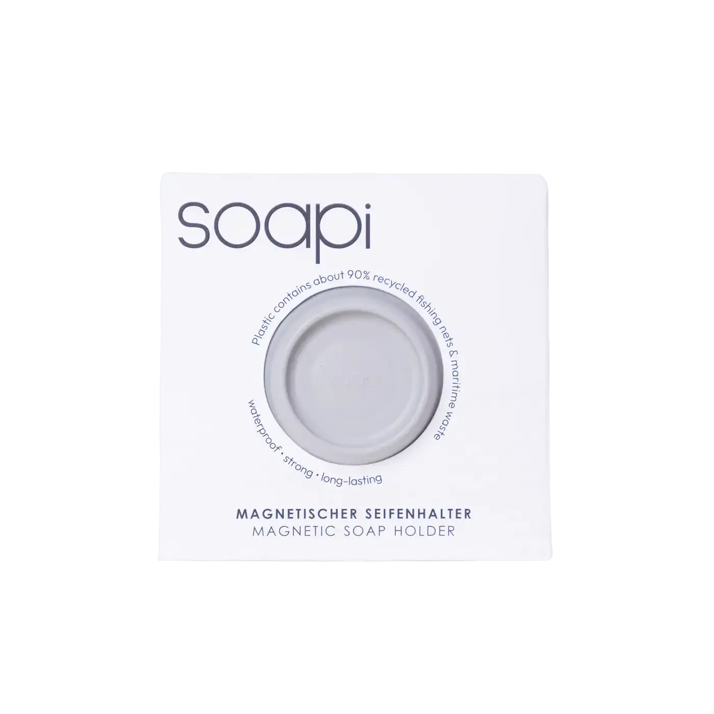 A white package labelled soapi contains a round, grey magnetic soap holder. Text on the packaging highlights recycled plastic, waterproof and strong features, and provides product name in English and German. Gate21.ee