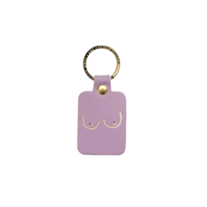 The Boob Key Ring - Lilac is a rectangular lavender leather keyring with a gold keyring, featuring a minimalist gold outline illustration of breasts on the front. Gate21.ee