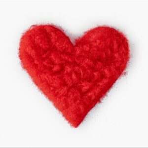A pink, textured felt heart inspired by Inkognito Postcards is centred against a plain white background. Gate21.ee