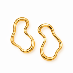 A pair of Aversa - BØLD Earrings in gold are displayed on a white background. Each earring showcases an abstract, irregular shape with smooth, wavy contours and a polished finish, without any visible clasps or fastenings. Gate21.ee
