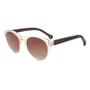 A pair of Costa Transparent Nude Sunglasses featuring round, light transparent frames, dark brown temples, and brown gradient lenses, with the PARAFINA brand printed in gold on the side. Gate21.ee