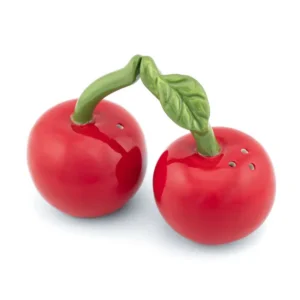 The Cherry - Salt & Pepper Shakers feature two red ceramic shakers shaped like cherries with green stems and leaves. The stems touch, and each shaker has holes on top for dispensing spices. Gate21.ee