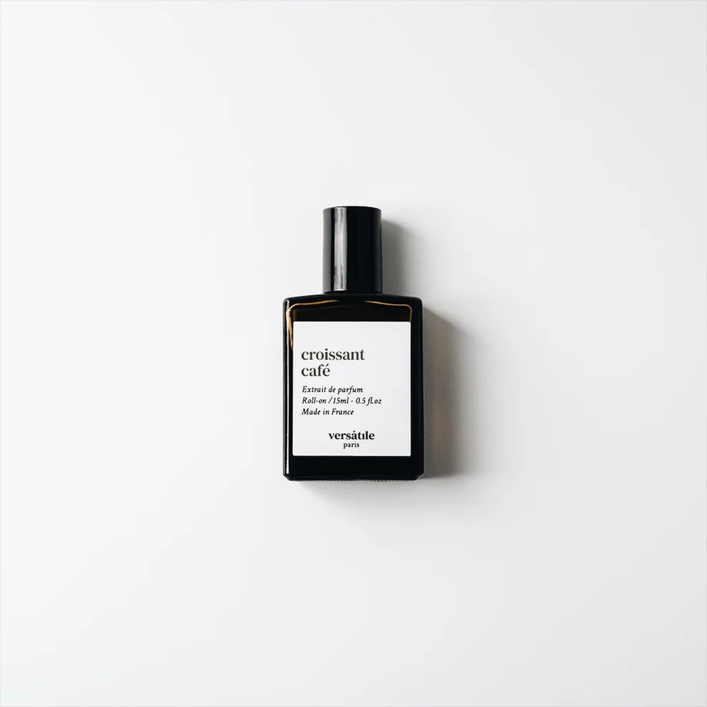 A black Croissant Café roll-on EDP bottle labelled "Extrait de Parfum, Made in France, versatile paris" sits on a white background. This 30ml unisex scent is by YMC Bon parfumeur. Gate21.ee