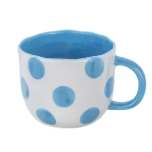 The Surprise Dog - Cup is a white ceramic mug with large blue spots, a matching blue handle and interior, and a slightly wavy rim. Gate21.ee