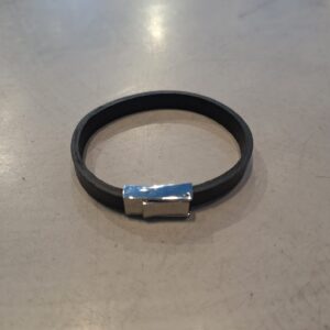 The ERER - Silver Clasp Bracelet, featuring a black band and silver rectangular clasp, is displayed on a light grey, slightly textured surface. Gate21.ee