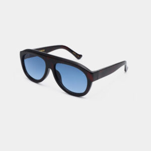 A pair of Kjærbede Rio - Demi Tortoise sunglasses with dark, thick frames and blue-tinted lenses is shown on a plain white background, with the arms of the glasses angled backwards. Gate21.ee