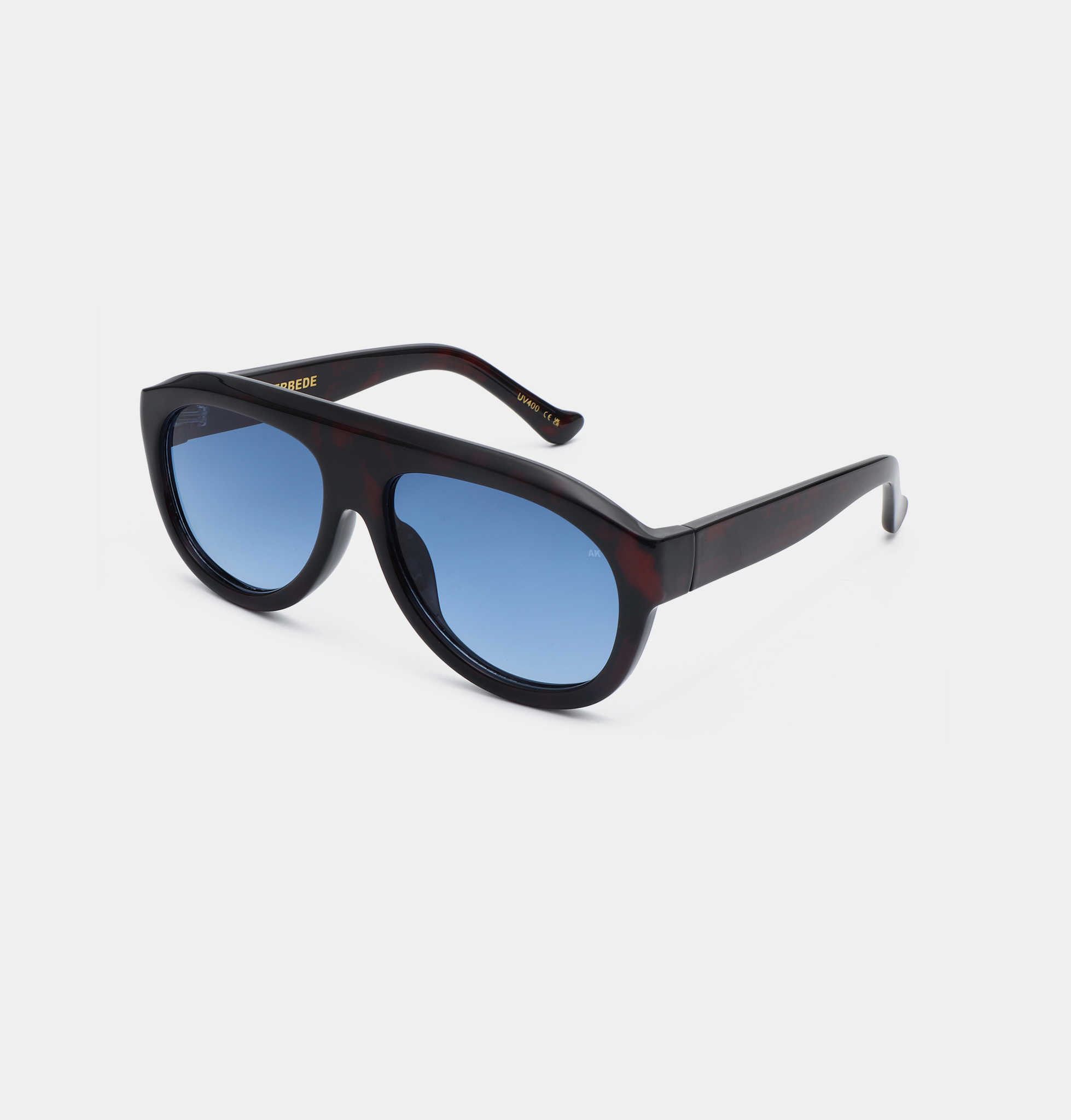 A pair of Kjærbede Rio - Demi Tortoise sunglasses with dark, thick frames and blue-tinted lenses is shown on a plain white background, with the arms of the glasses angled backwards. Gate21.ee