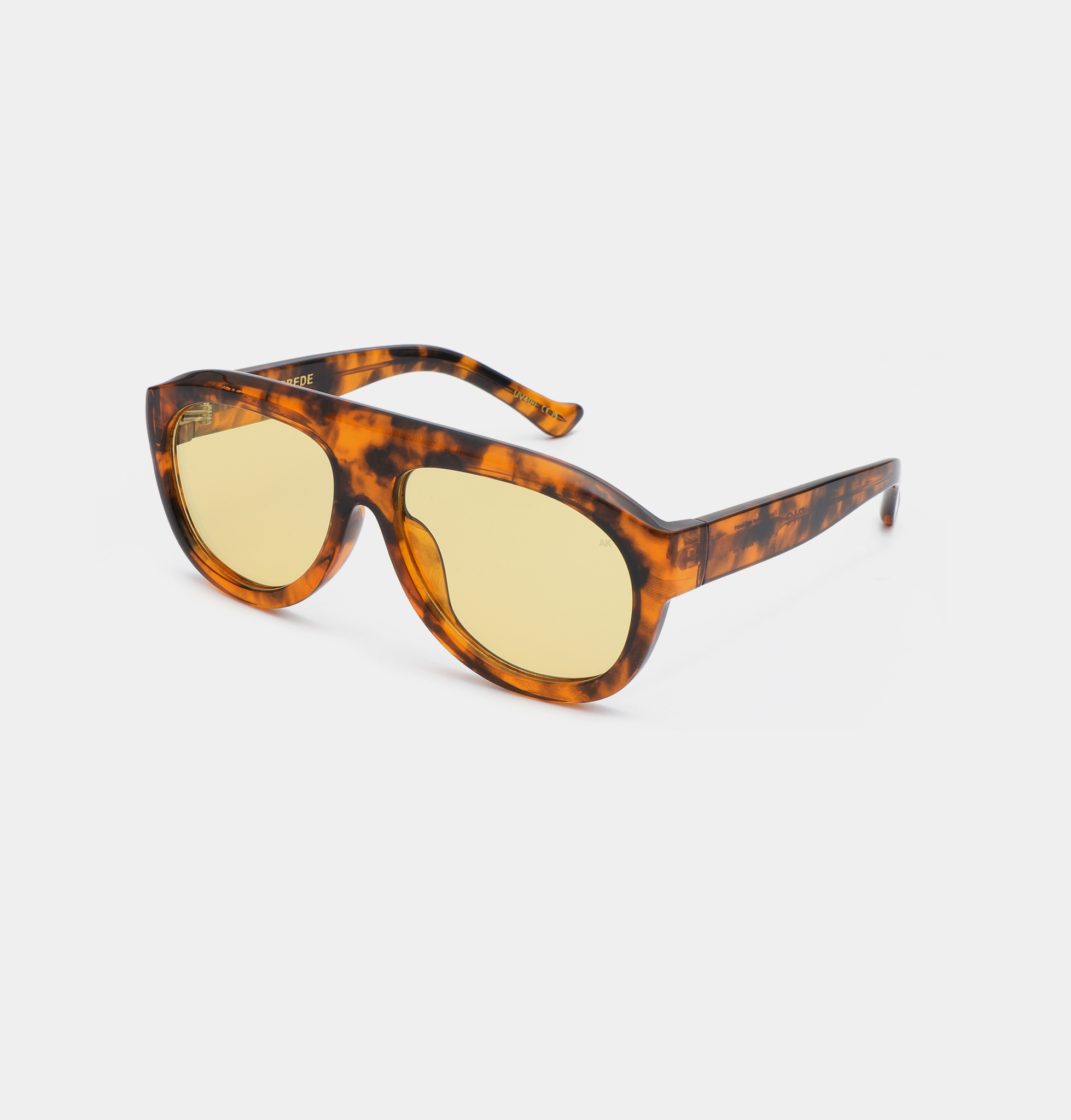 The Rio - Havana sunglasses by A. Kjærbede feature a tortoiseshell pattern with yellow-tinted lenses, thick frames, and a slightly oversized shape, displayed on a white background. Gate21.ee