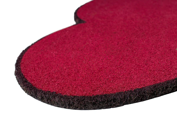 A close-up of the Doormat - "Heart": a red, heart-shaped mat with a textured surface and black edging on a white background—an ideal accent beside your handheld fan for hot summer days. Gate21.ee