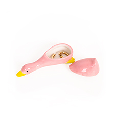 The Duck - Jewellery Box is a pink ceramic duck-shaped trinket box featuring a removable tail lid. Displayed open with gold rings inside, it sits elegantly on a white background—a playful companion for any collection, much like the dreamy cat jewellery plate by Hello Ferretti. Gate21.ee