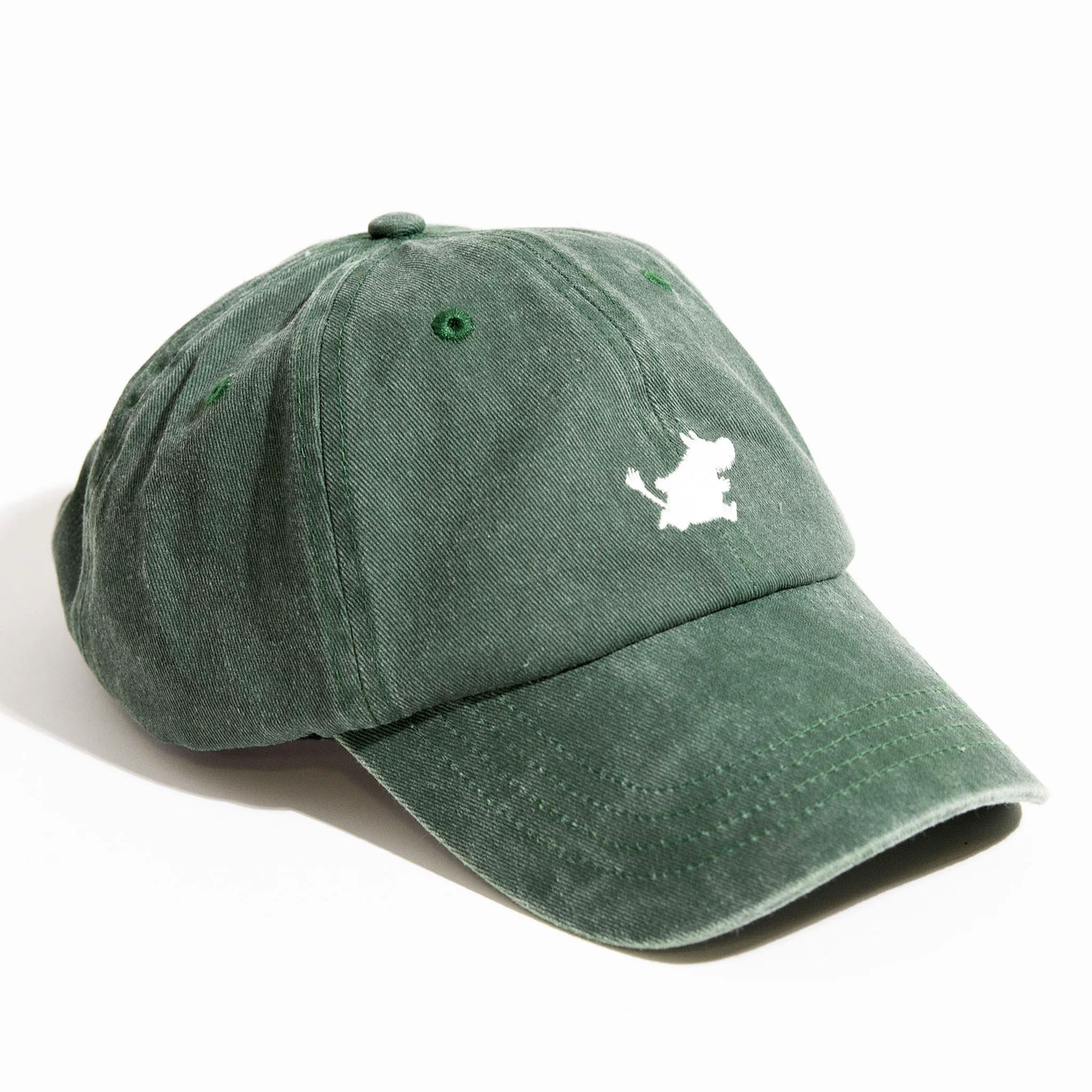 The Moomin Cap - Green features a white embroidered logo of a small character on the front, reminiscent of those seen on Moomin keyrings. This green baseball cap has visible stitching and a slightly curved brim. Gate21.ee