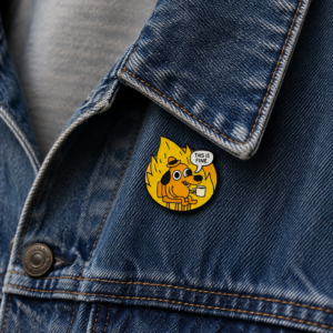 A close-up of a blue denim jacket’s lapel features the "This is Fine - Pin," showing a cartoon dog surrounded by flames, holding a cup, with a speech bubble reading “THIS IS FINE.”. Gate21.ee