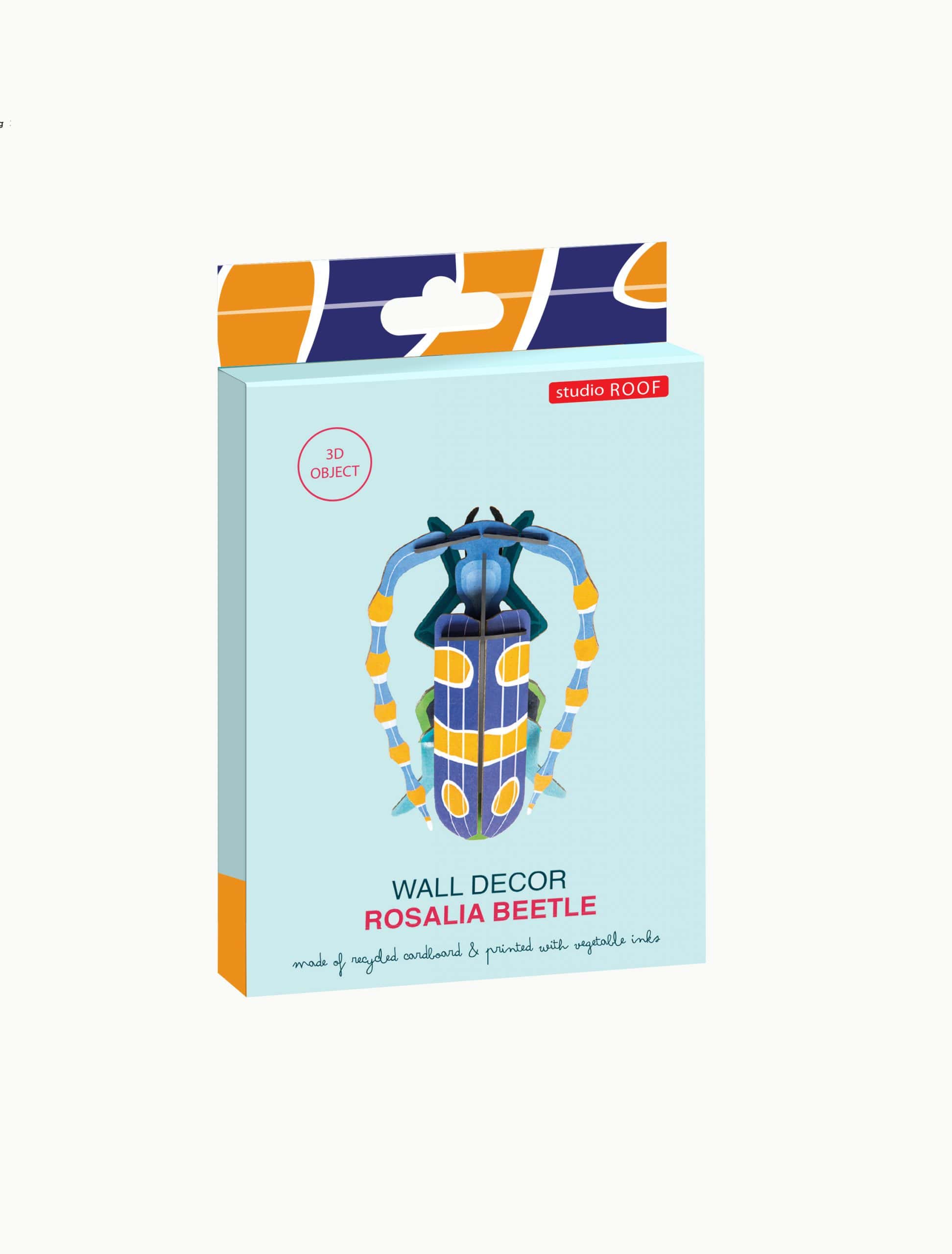 A product box for the Rosalia Beetle from studio ROOF showcases a vibrant beetle illustration alongside items from the StudioROOF dragonfly collection, and highlights that it is a 3D object crafted from recycled cardboard and printed with vegetable inks. Gate21.ee