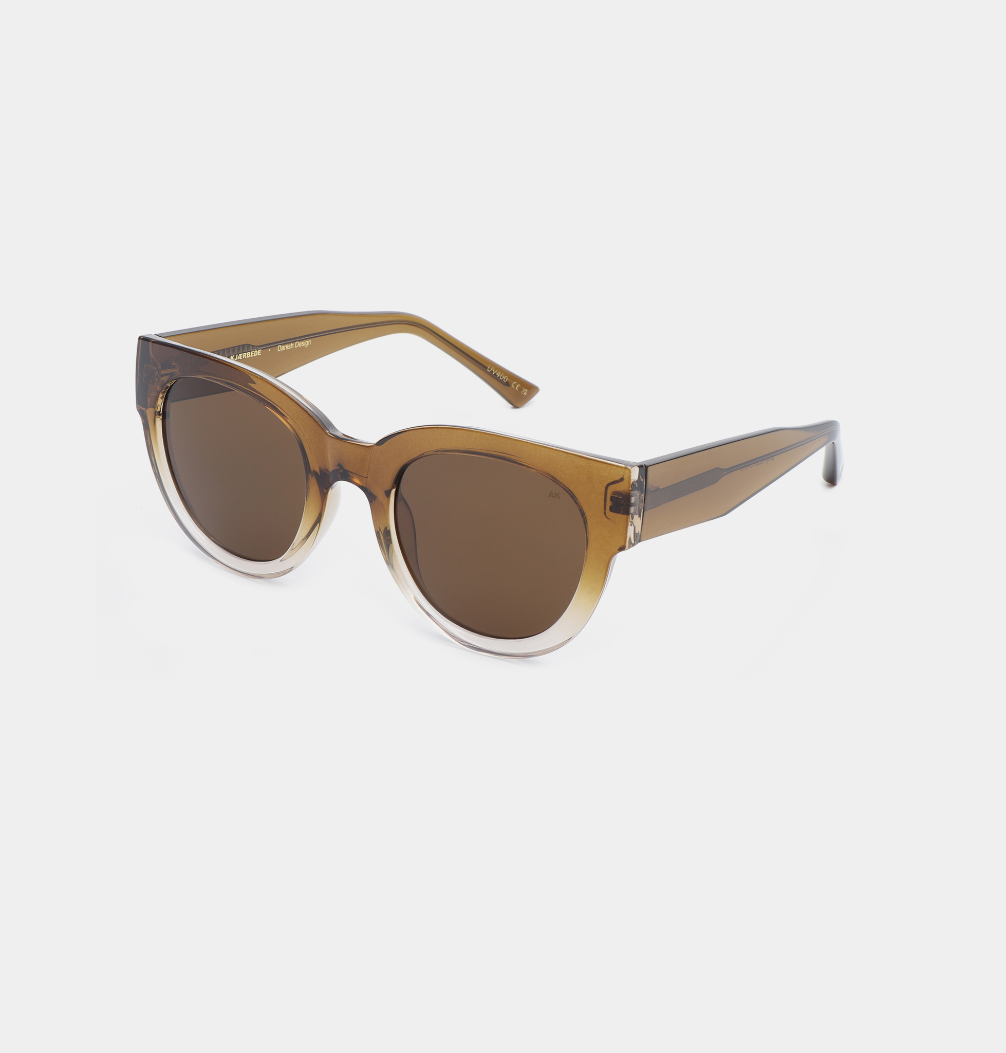 A pair of LILLY - Smoke Champagne sunglasses by A. Kjærbede, featuring round lenses with thick, semi-transparent brown frames and wide arms, displayed on a plain white background. Gate21.ee