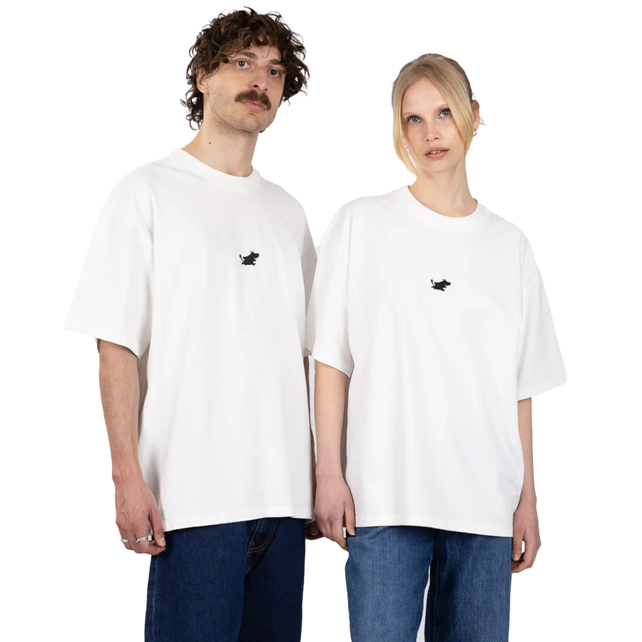 Two people stand side by side against a plain white background, both wearing the Moomin Heavy Ts in white — loose-fit T-shirts featuring a small black embroidered design on the left chest — paired with blue jeans. Gate21.ee