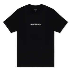 The Must Be Nice Tee - Black by RIPNDIP, a short-sleeve shirt laid flat against a plain white background, features “MUST BE NICE.” printed in bold white uppercase letters, centred on the chest. Gate21.ee