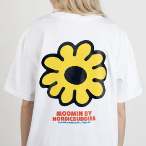 A person wearing the Moomin Ts - Troll’s Flower, a white T-shirt featuring a large yellow flower graphic and “MOOMIN BY NORDICBUDDIES DESIGNED IN HELSINKI, FINLAND” printed in red and blue on the back. Gate21.ee