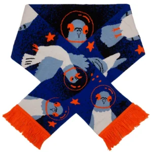 A blue Pigeon - Organic scarf from Kabak features illustrated birds wearing space helmets, orange fringe and stars, along with blue and white patterns throughout the fabric. Gate21.ee