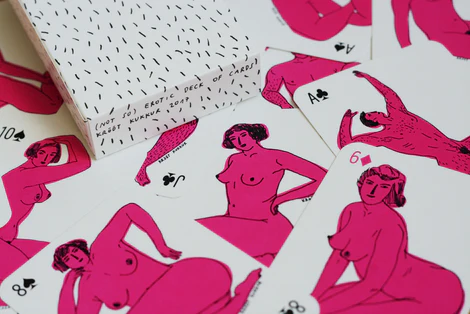 Here is a rewritten version of the sentence using the provided product data: A pack of Krõõt Kukkur Playing Cards - Nudes, featuring minimalist pink nude illustrations, is laid out on a white surface showing various cards including clubs and spades. Gate21.ee