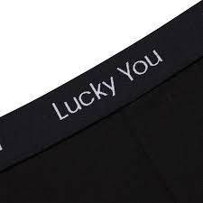 A close-up of the black waistband on the Lucky You Boxers - Black, with “Lucky You” printed in white text. Gate21.ee