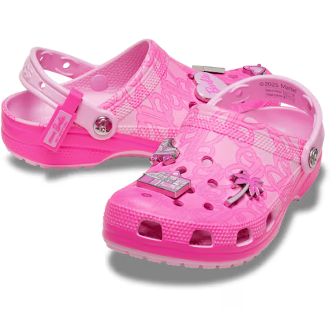 A pair of Crocs Barbie® Classic Clog in bright pink with a semi-transparent finish, decorated with Barbie-themed charms such as a palm tree, a convertible, and the Barbie logo. These clogs feature ventilation holes and a back strap. Gate21.ee