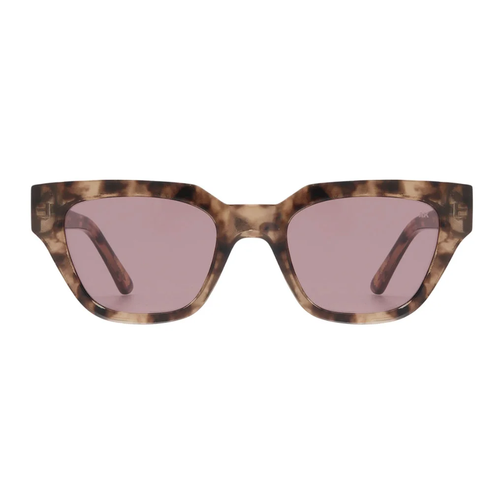 Front view of the KAWS - Coquina sunglasses by A. Kjærbede, featuring a tortoiseshell-patterned frame with rectangular, slightly angled lenses tinted in light purple. The arms are also tortoiseshell, set against a plain white background. Gate21.ee
