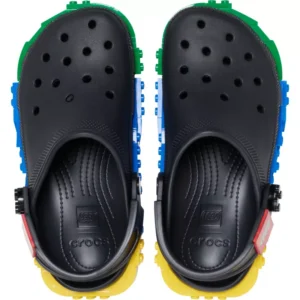 A pair of Crocs™ 4LW System Clog shoes in black, featuring colourful LEGO brick-inspired embellishments along the sole edges, shown from a top-down perspective on a white background. Gate21.ee