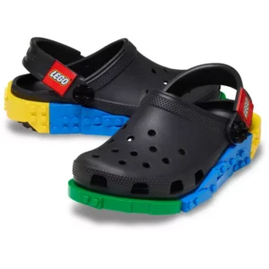 A pair of Crocs™ 4LW System Clog in black, featuring colourful LEGO brick designs around the soles and LEGO-branded straps at the back. Gate21.ee