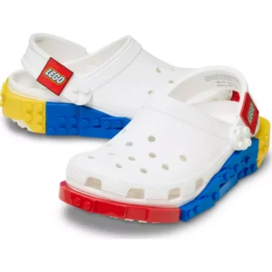 A pair of Crocs™ 4LW System Clog in White, showcasing perforated uppers and soles with heel straps inspired by vibrant LEGO bricks in red, yellow, and blue. Gate21.ee