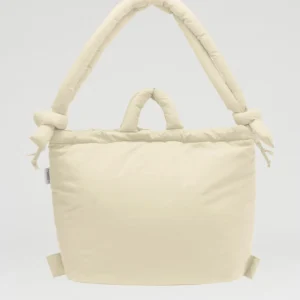 A butter yellow, padded ÖLEND Ona Soft Bag with two short handles and two longer, knotted shoulder straps, displayed against a plain white background. The bag has a soft, quilted appearance. Gate21.ee