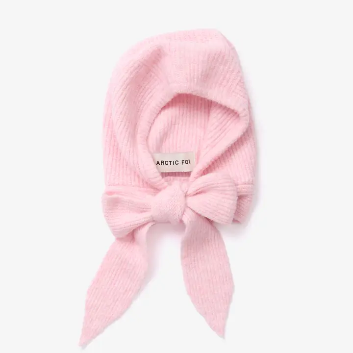 A light pink, ribbed knit baby bonnet called “The Bonnet - Light Pink - Recycled,” featuring a wide tie at the chin and evoking the cosy style of Arctic Fox Reykjavik hand warmers. The inside label reads “ARCTIC FOI.” The bonnet is displayed flat on a plain white background. Gate21.ee
