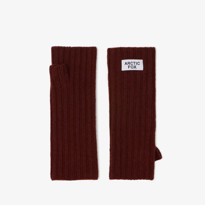 A pair of ribbed, dark walnut brown fingerless gloves, designed as Merino Wool Fingerless Gloves, are laid flat on a white background. One glove displays a rectangular label with the text ARCTIC FOX. Gate21.ee